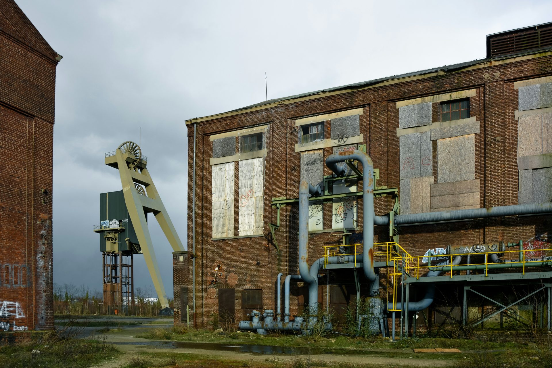 An old factory building with a crane in front of it